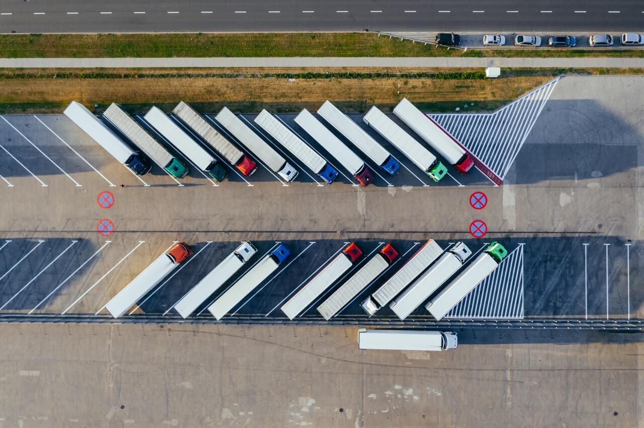 aerial-photography-of-trucks-parked-2800121